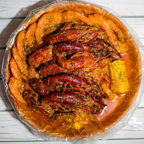Ben's Crab seafood boil with crawfish, shrimp, and corn on the cob in a bag.