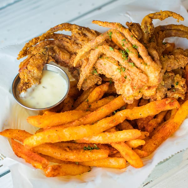 Ben's Crab fried soft-shell crab and seasoned fries with a side of dipping sauce.