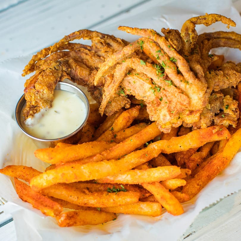 Ben's Crab fried soft-shell crab and seasoned fries with a side of dipping sauce.
