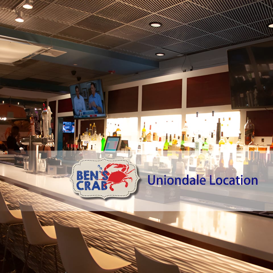 Ben's Crab Uniondale Location bar area with bottles of liquor, beer taps, and bar stools.